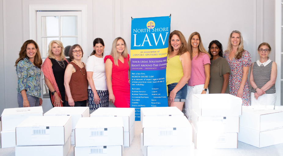 Members of North Shore Law packed boxes with gifts for women undergoing breast cancer treatment.